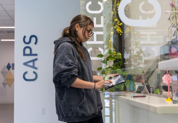 person checking in at kiosk
