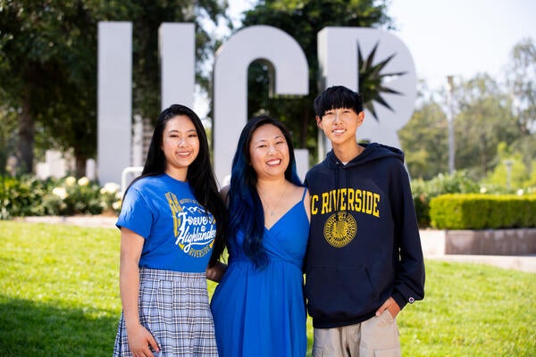 family in front of letters